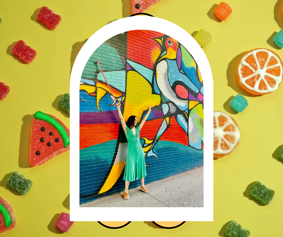 marissa next to mural image on a background of sugared watermelons and oranges