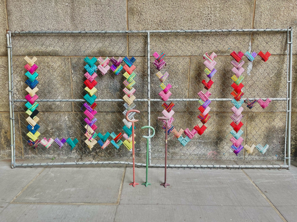 canes in front on embroidered love fence