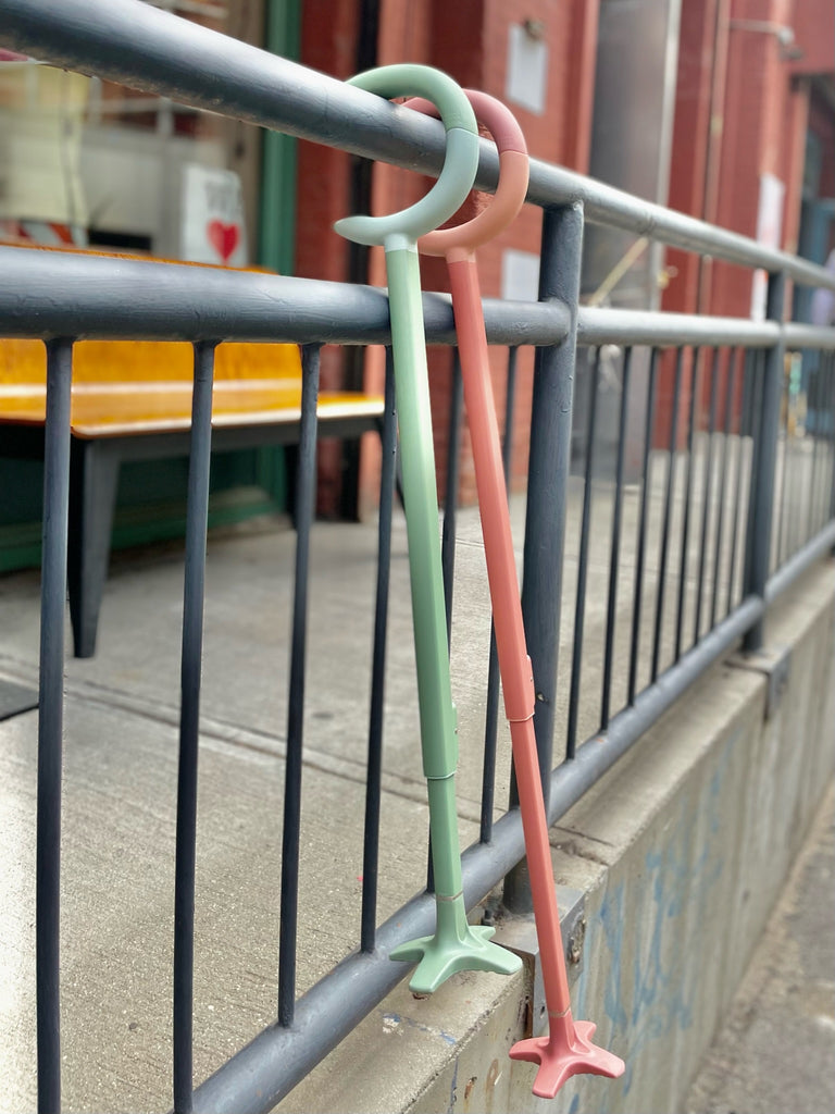 green and pink c-grip hanging on rail