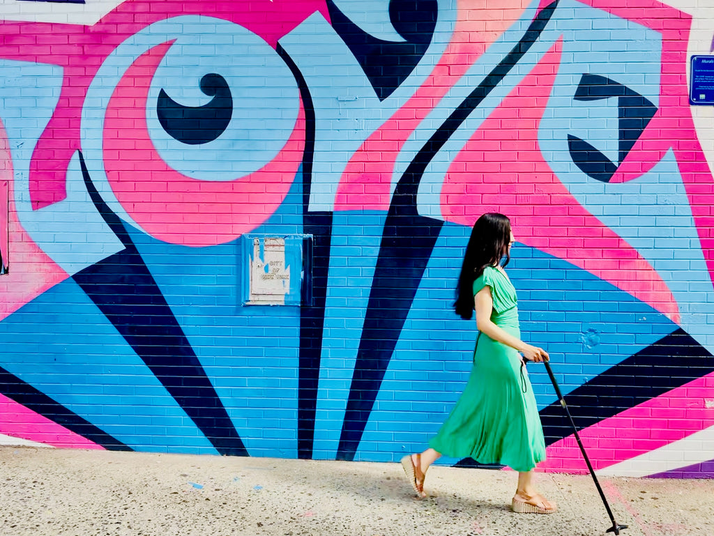 marissa walking next to love mural