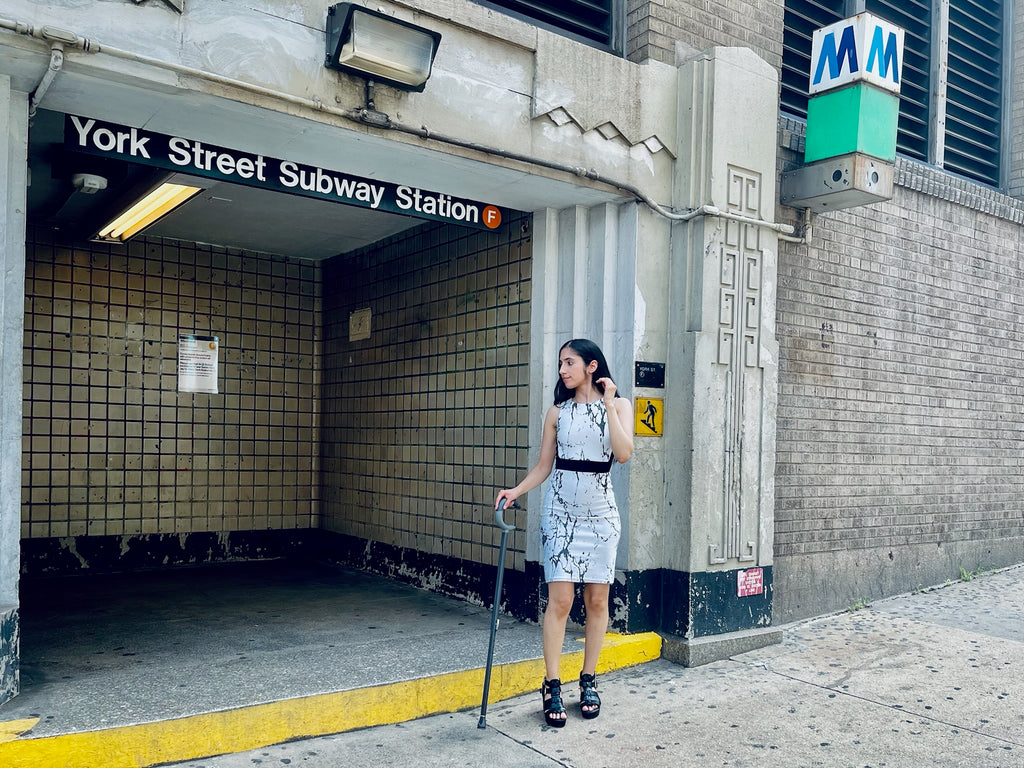 Marissa with cane next to subway