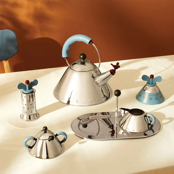 a tea kettle with salt and pepper shakers and a sugar holder