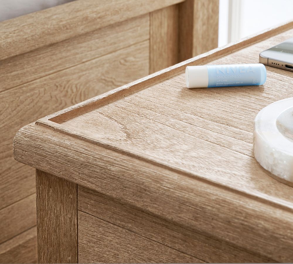 Wooden desk surface with a phone and other items