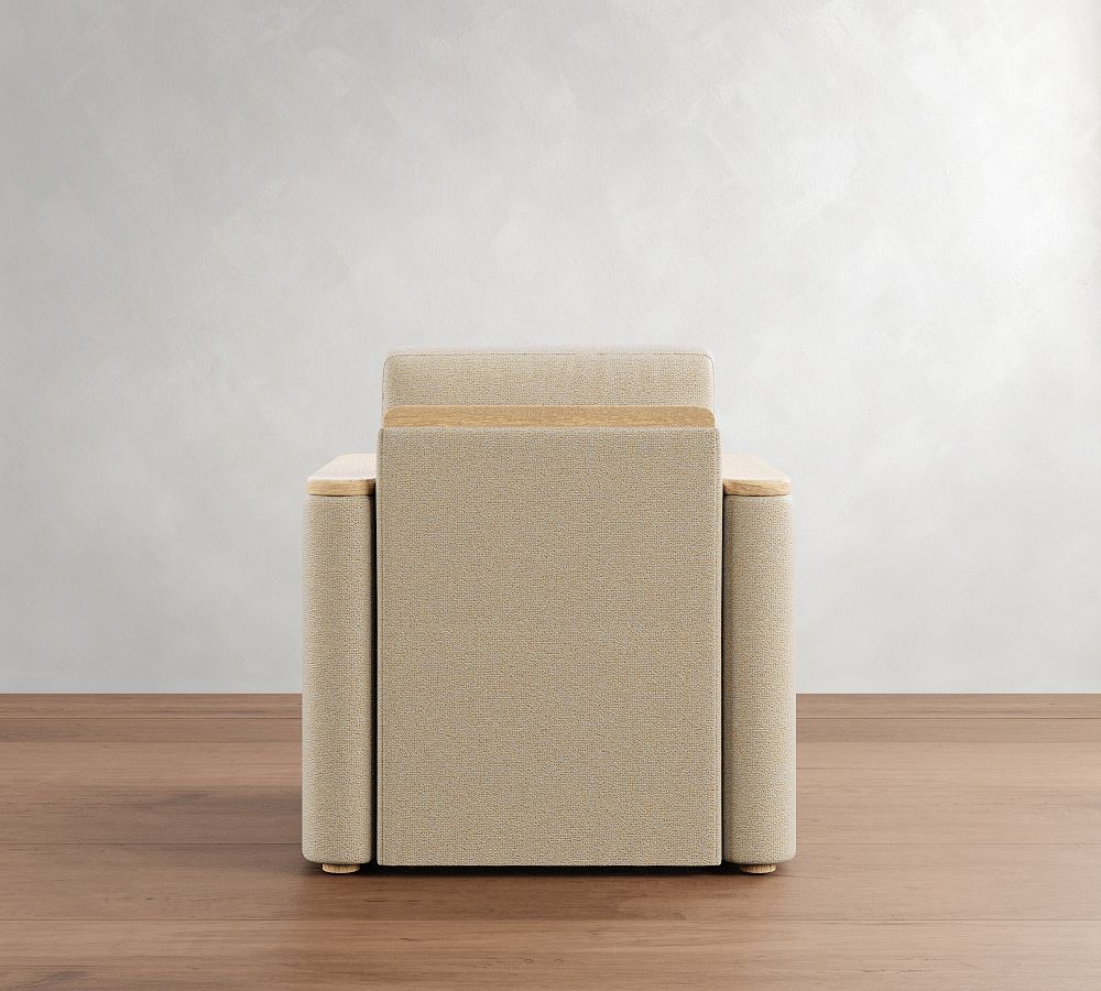 Beige armchair on a wooden floor with a plain white wall background