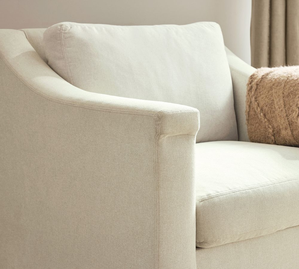 Beige sofa with a textured surface and a brown pillow in a neutral setting