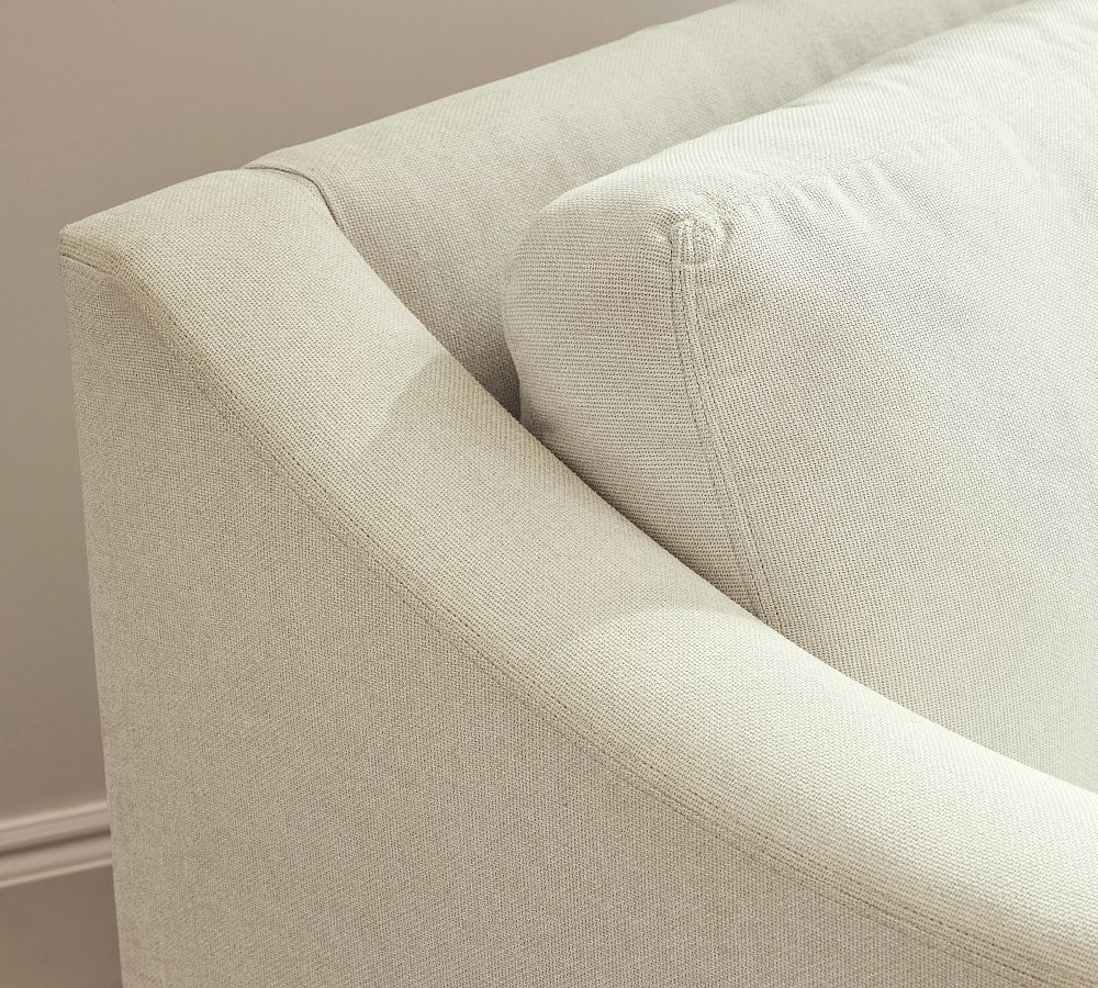 Close-up of a beige upholstered chair with a neutral background